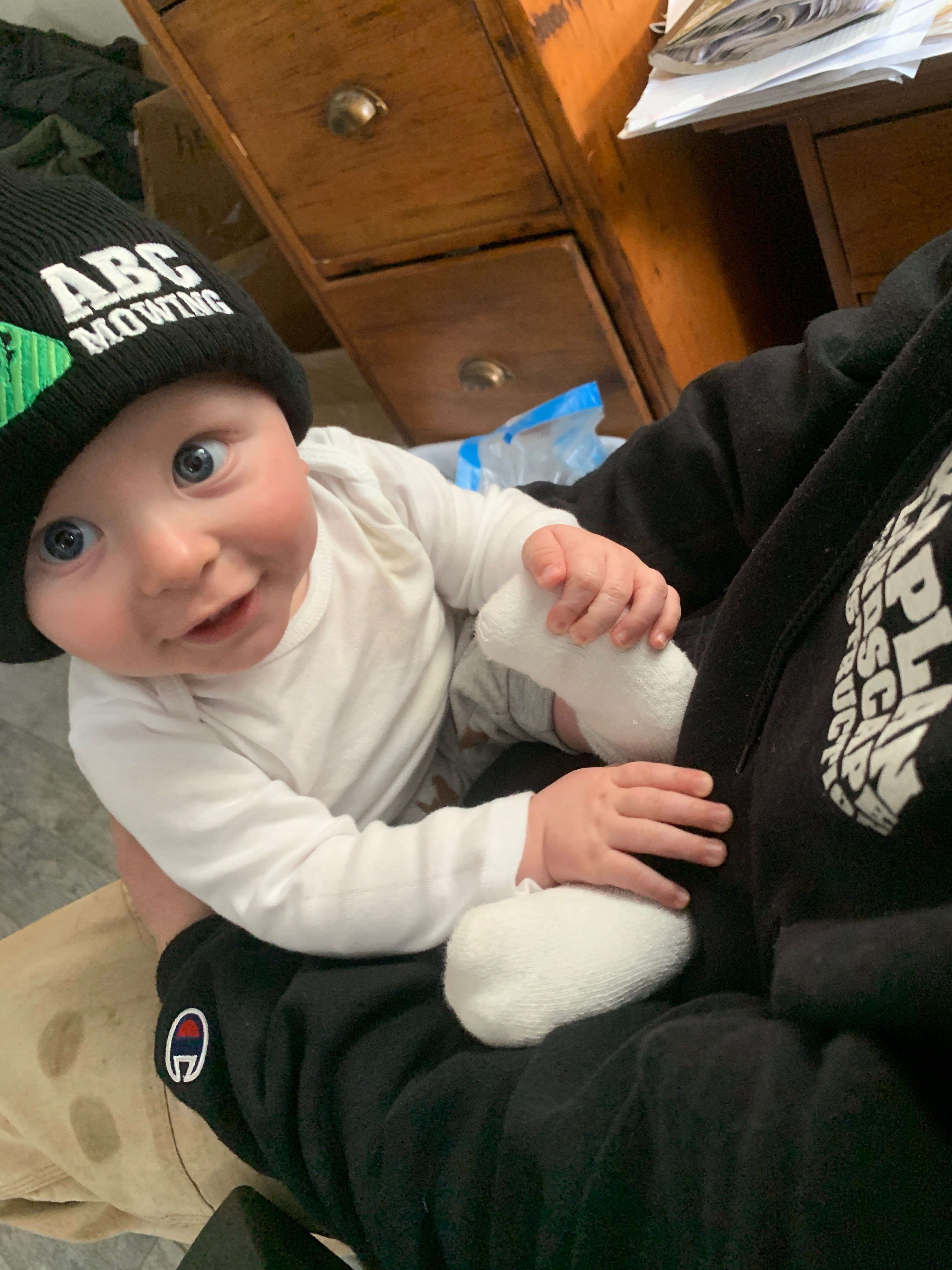 Baby wearing ABC Mowing beanie