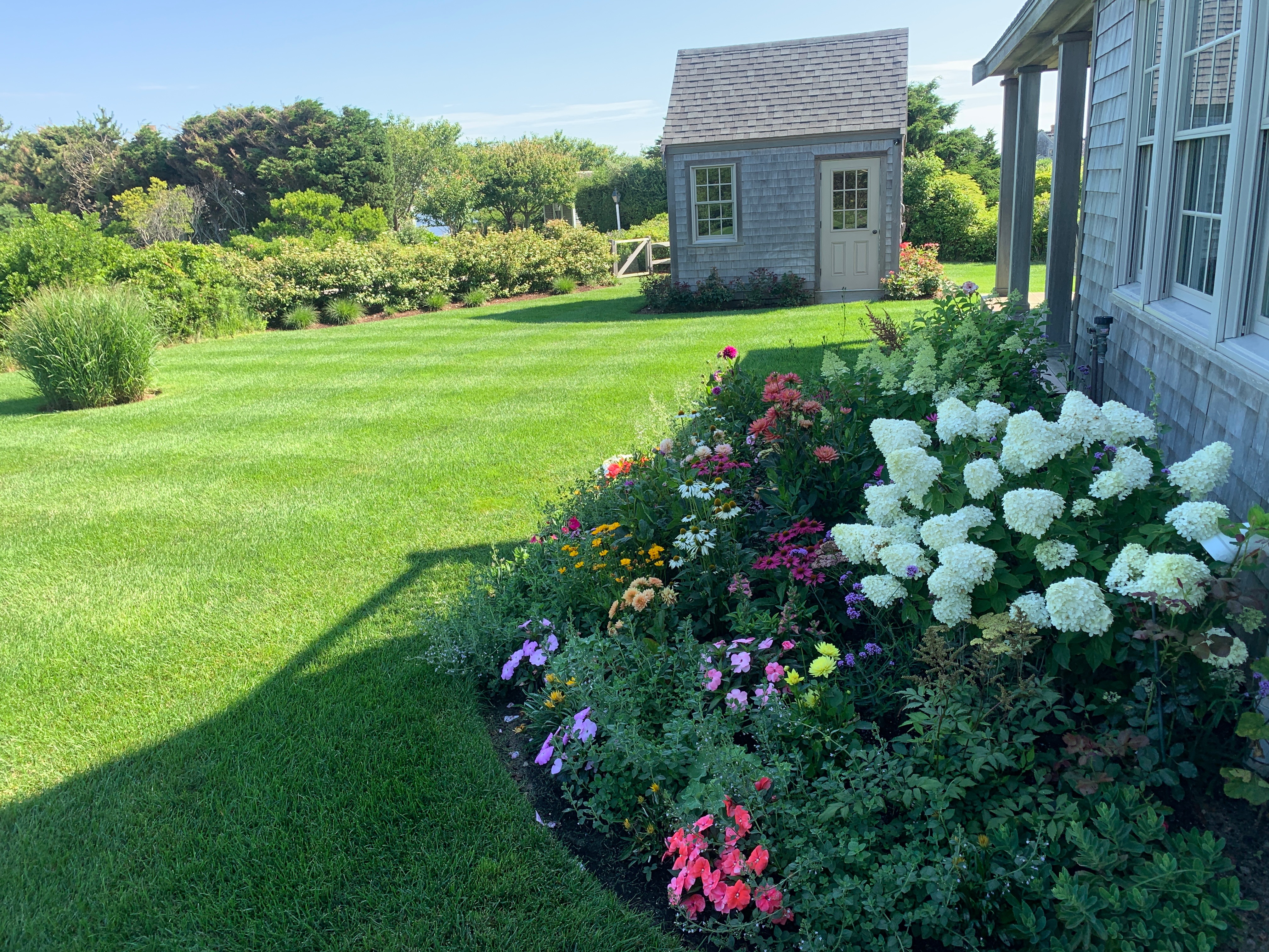 Colorful garden bed along Nantucket home